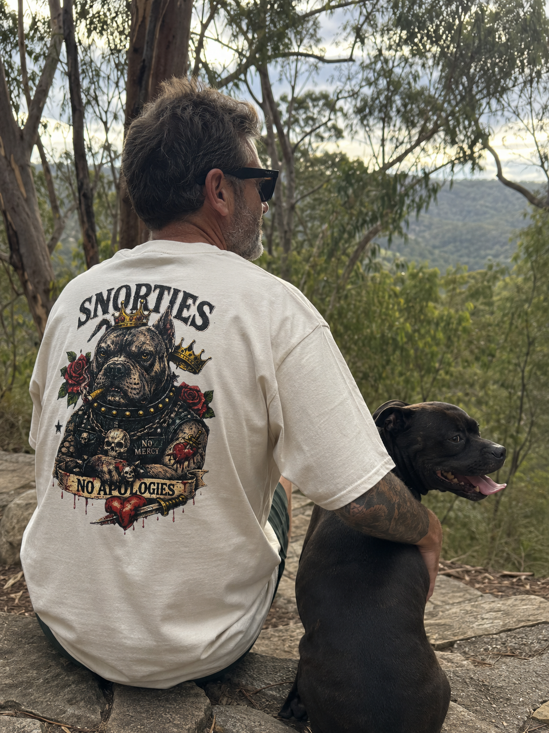 Snorties Inked Enforcer Staffy T-shirt featuring a detailed Staffy dog graphic on a black cotton tee.