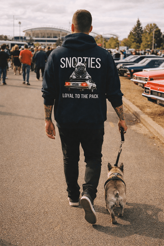 Snorties Frenchie A9X hoodie featuring a French Bulldog graphic, modeled by a person outdoors, showcasing casual streetwear style.