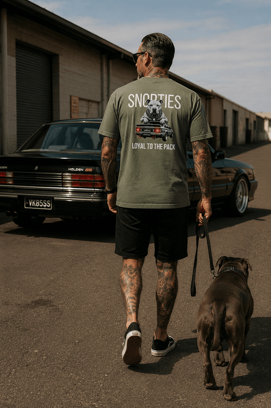 Snorties Staffy VK Commodore logo displayed on a car badge, featuring vibrant colors and detailed design elements.
