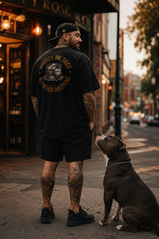 Whiskey Ink Dogs oversized T-shirt by Snorties featuring a graphic print of whiskey bottles and dogs on soft fabric.